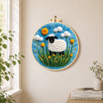 Black-faced sheep with giant yellow flowers needle felt wall art displayed in a bright home interior