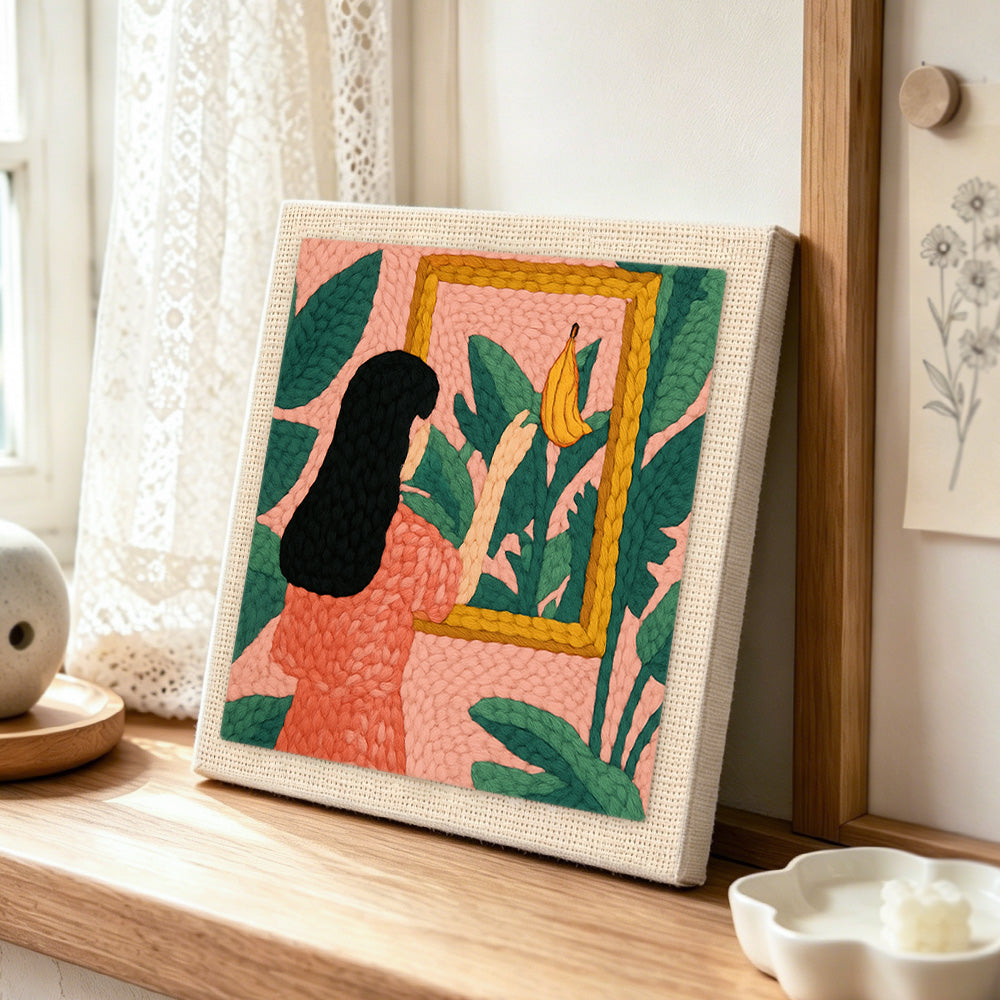 Black hair woman, tropical leaves and framed banana punch needle artwork displayed on a table