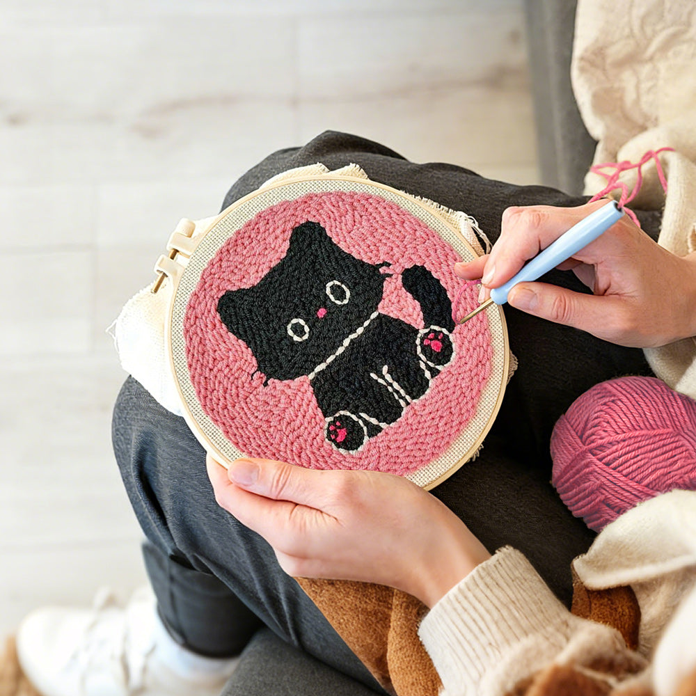 Creating handmade black kitten punch needle artwork