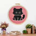 Finished black kitten artwork displayed on a wall
