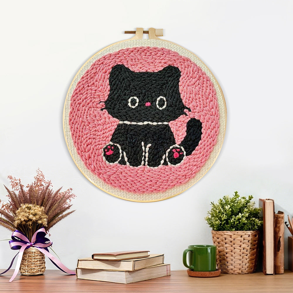 Finished black kitten artwork displayed on a wall
