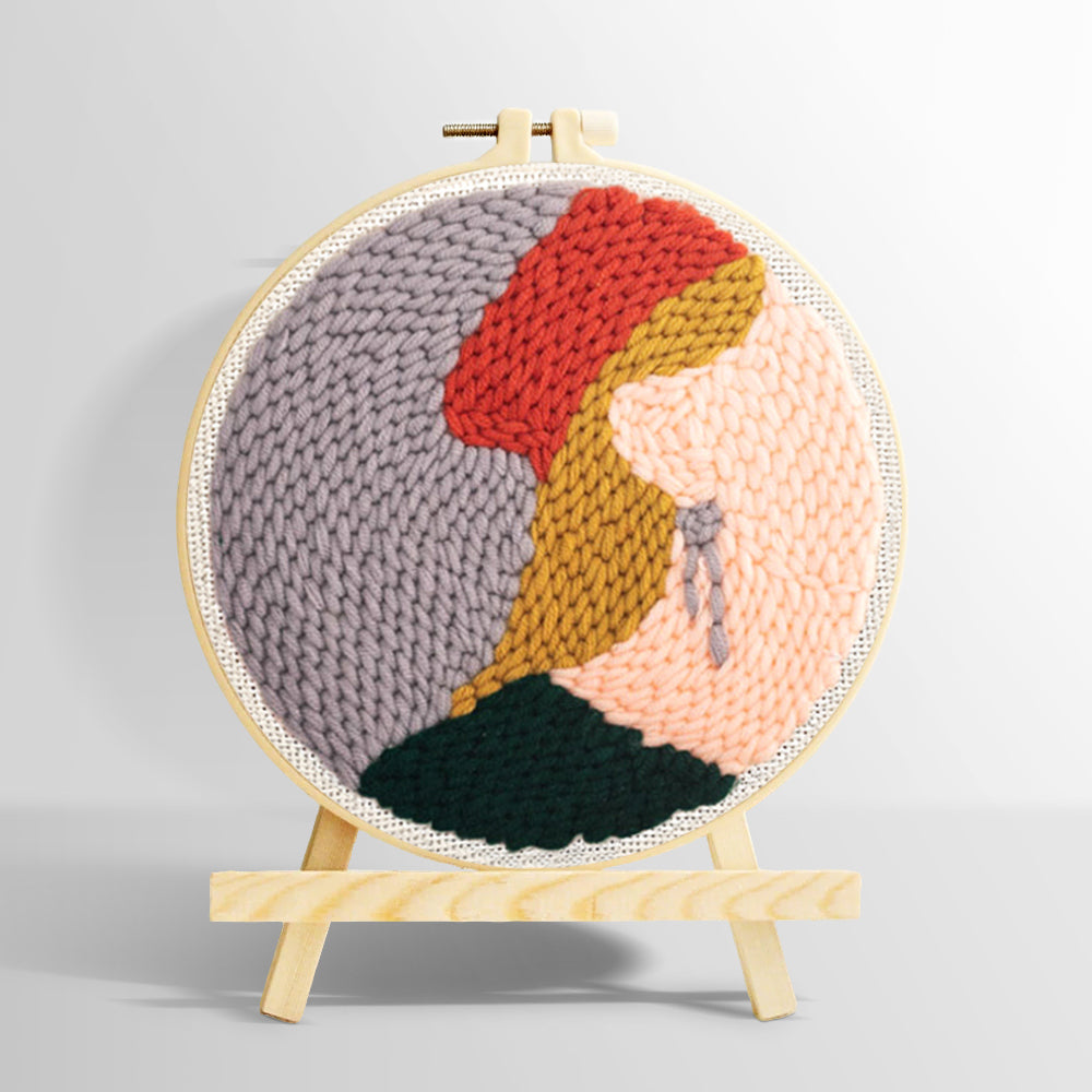 Blonde woman in red hat punch needle kit for beginners