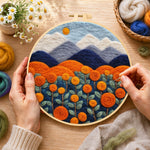 Creating the blooming orange roses and mountains wool painting by hand with a felting needle
