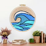Finished blue and teal rolling wave with beige sky artwork displayed on a wall