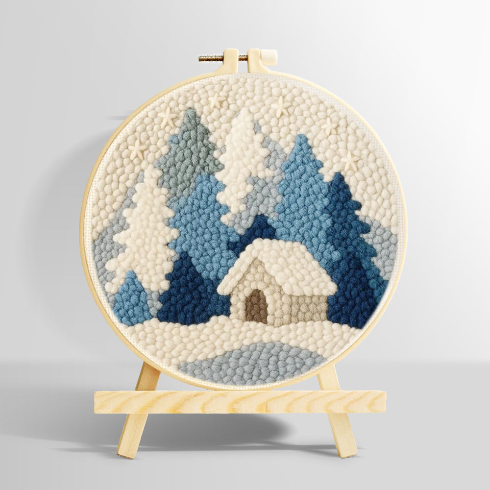 Blue and white snowy cabin in the woods punch needle kit for beginners