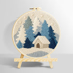 Blue and white snowy cabin in the woods punch needle kit for beginners