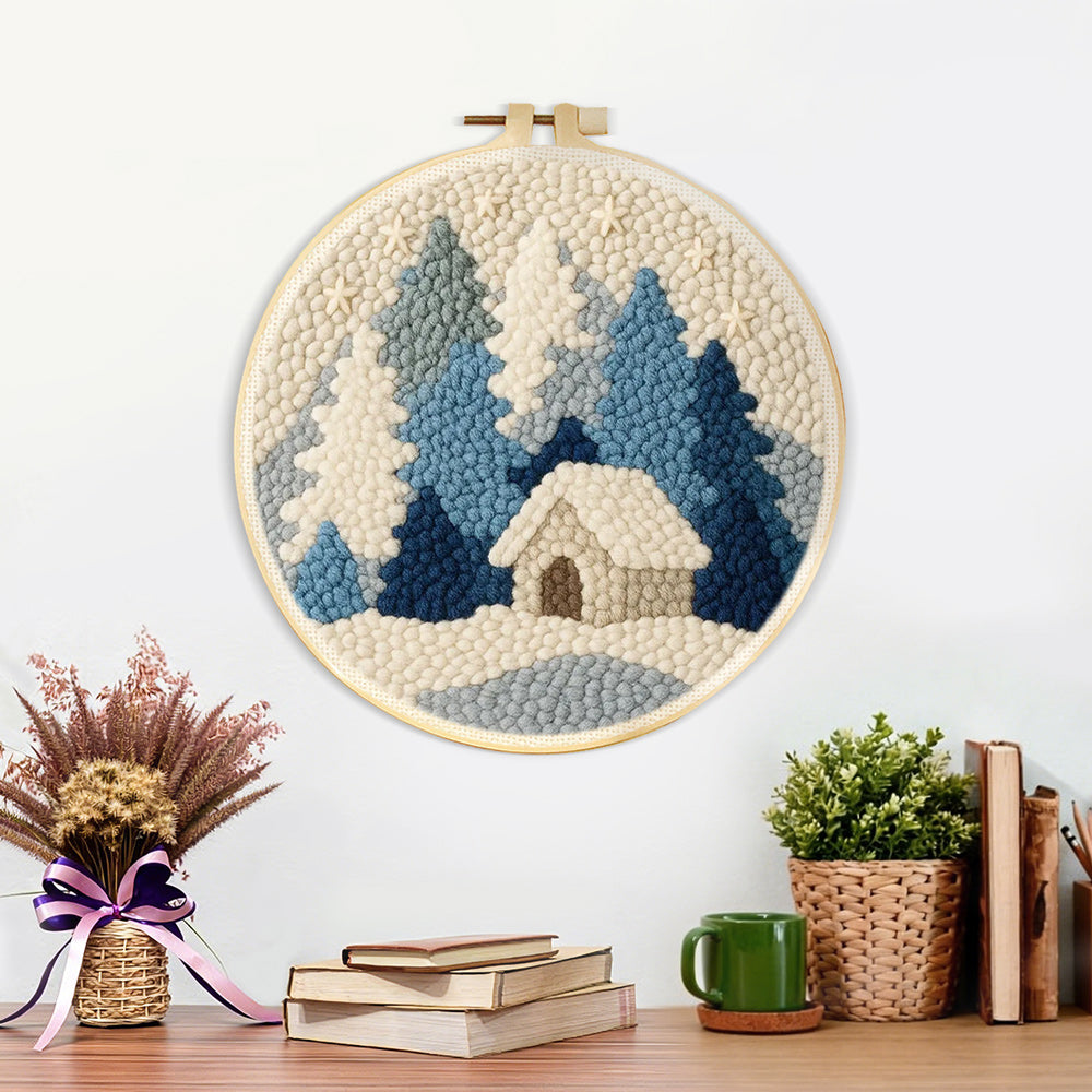 Finished blue and white snowy cabin in the woods artwork displayed on a wall