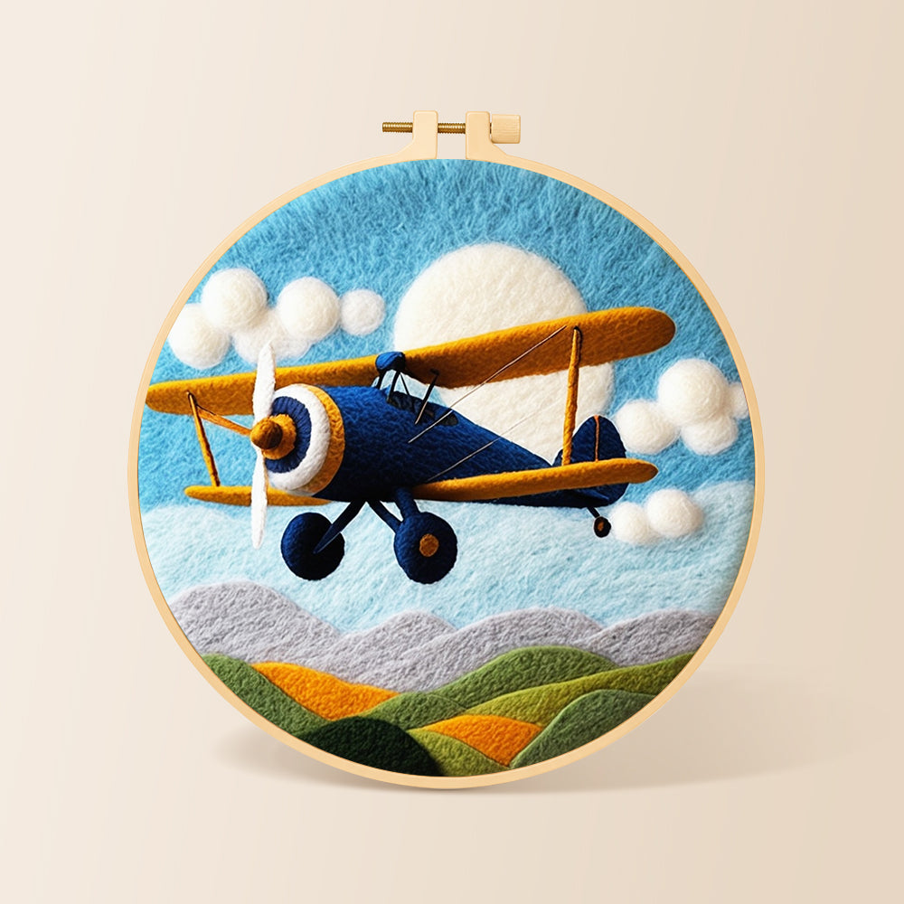Blue biplane flying needle felting kit for beginners with a round wooden frame