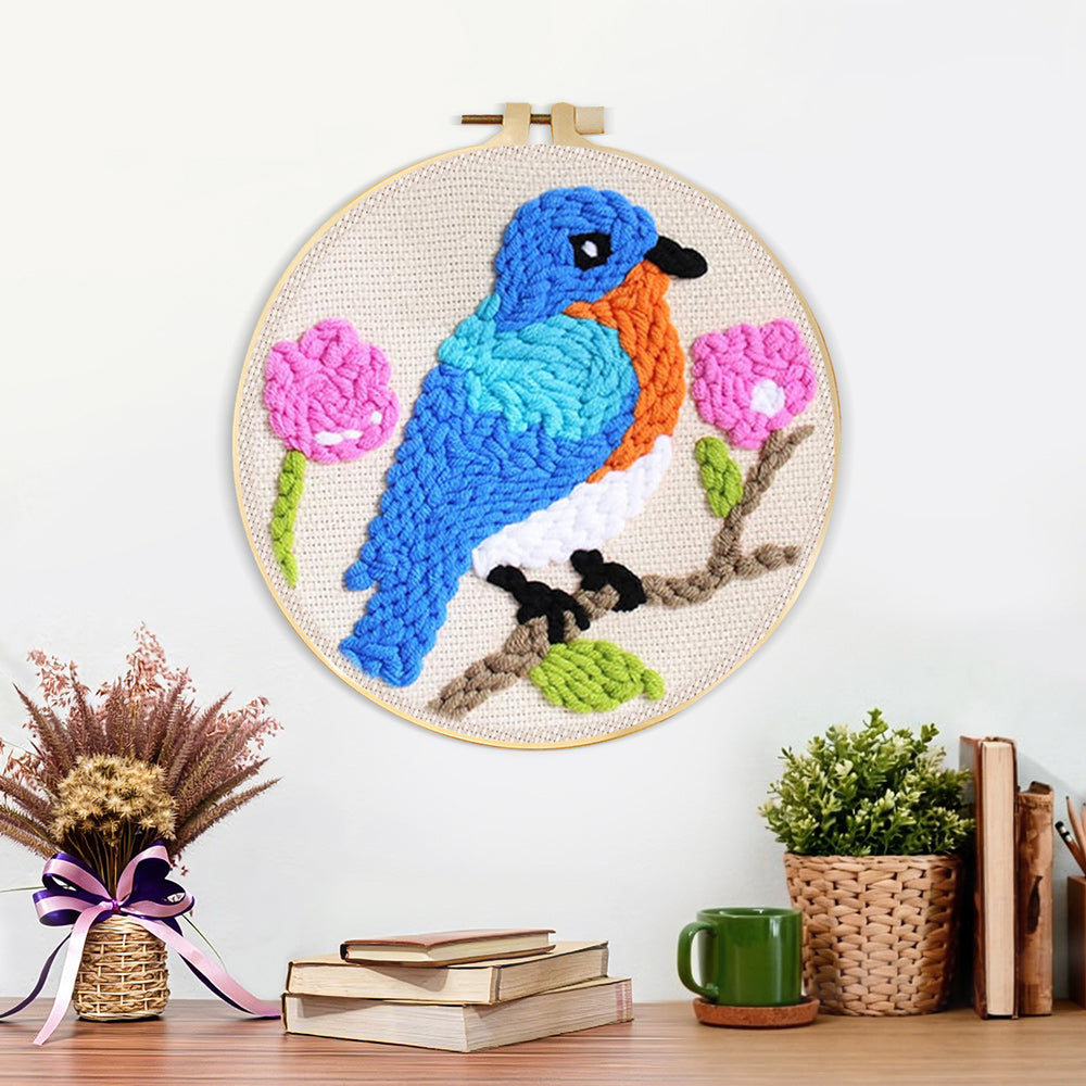 Finished blue bird and pink flowers artwork displayed on a wall