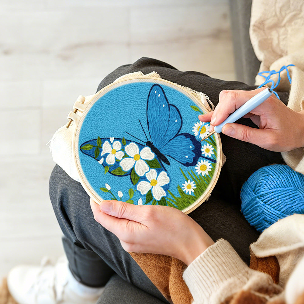 Creating handmade blue butterfly and white daisies punch needle artwork