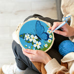 Creating handmade blue butterfly and white daisies punch needle artwork