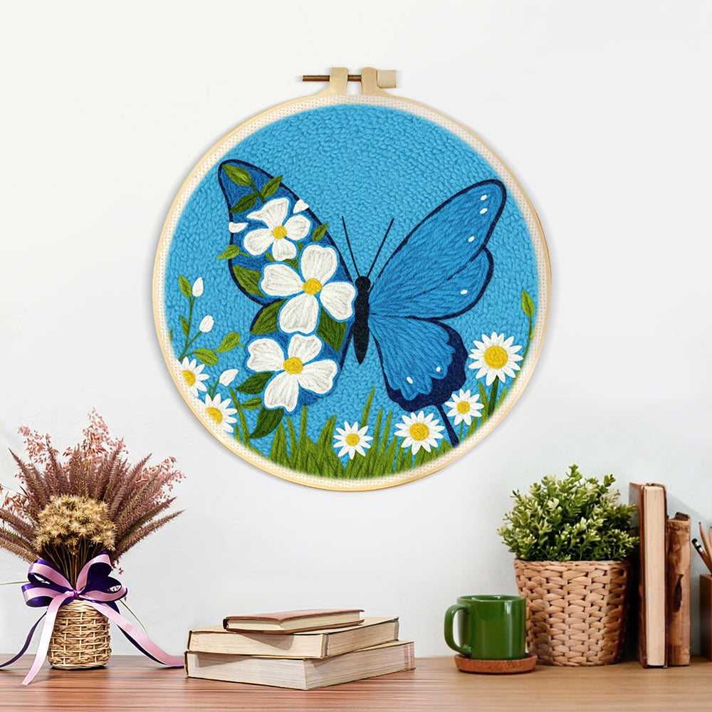 Finished blue butterfly and white daisies artwork displayed on a wall