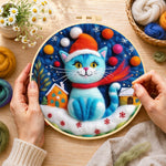 Creating the blue christmas cat with houses wool painting by hand with a felting needle