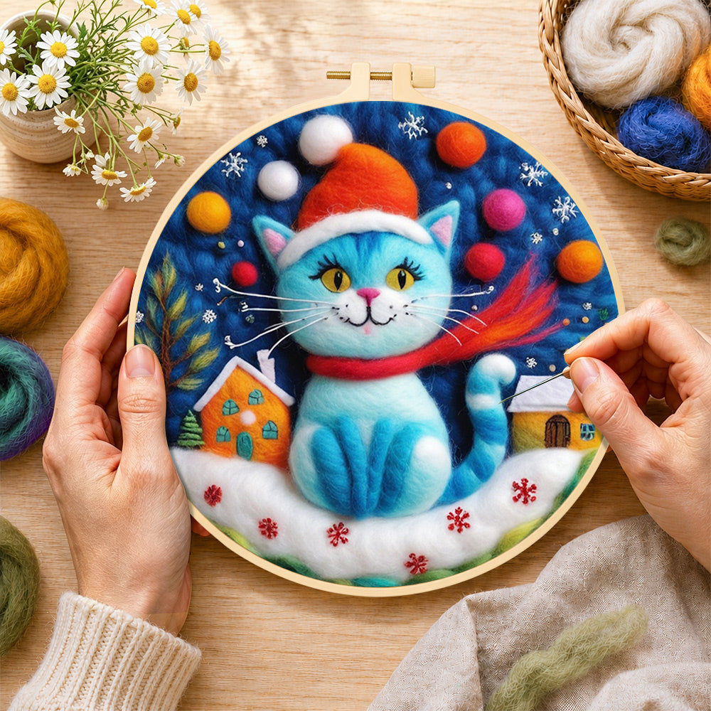 Creating the blue christmas cat with houses wool painting by hand with a felting needle