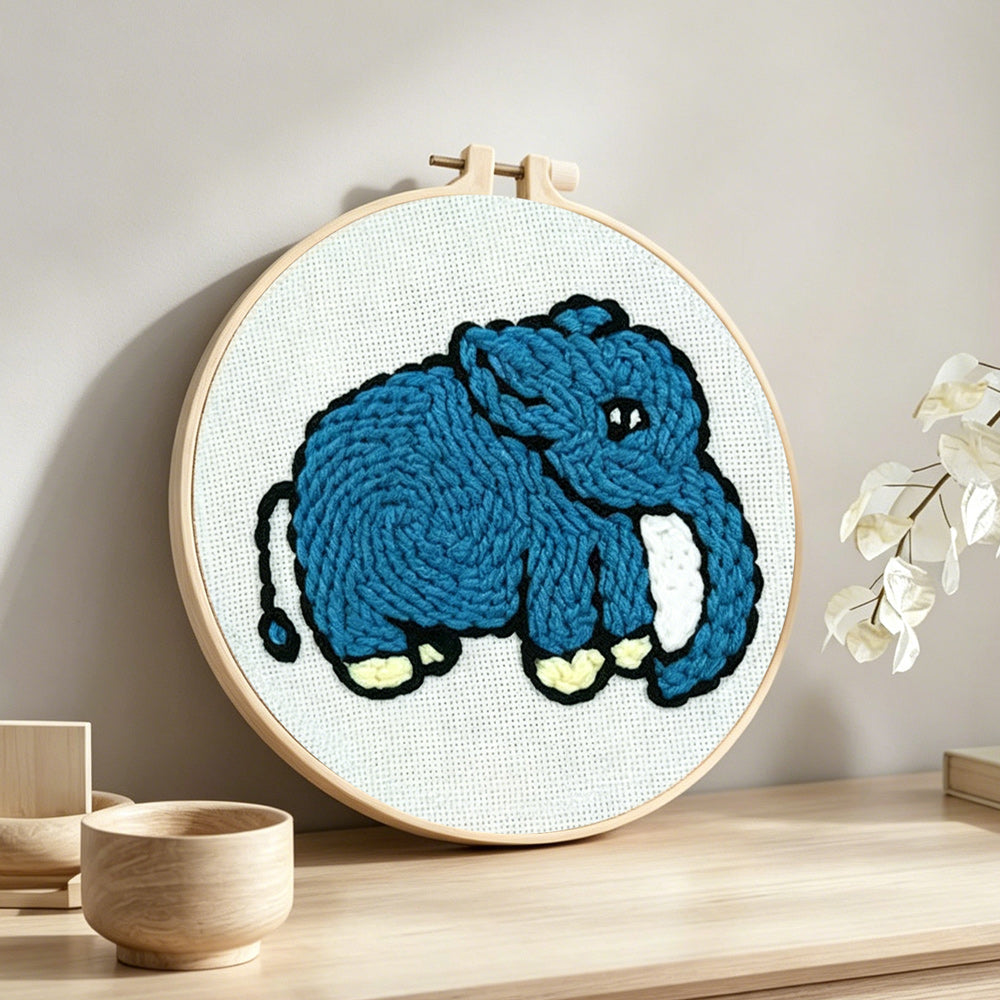 Blue elephant punch needle artwork displayed on a table