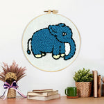 Finished blue elephant artwork displayed on a wall