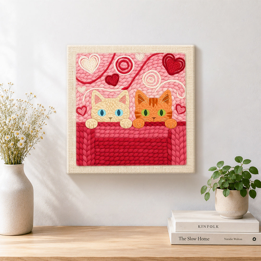Finished blue-eyed and green-eyed cats peeking artwork displayed on a wall