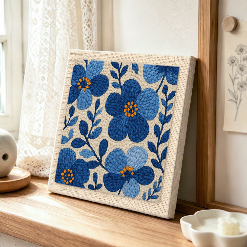 Blue florals punch needle artwork displayed on a table