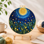 Finished blue flower meadow under the swirling night needle felting displayed on a wooden easel