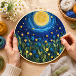 Creating the blue flower meadow under the swirling night wool painting by hand with a felting needle