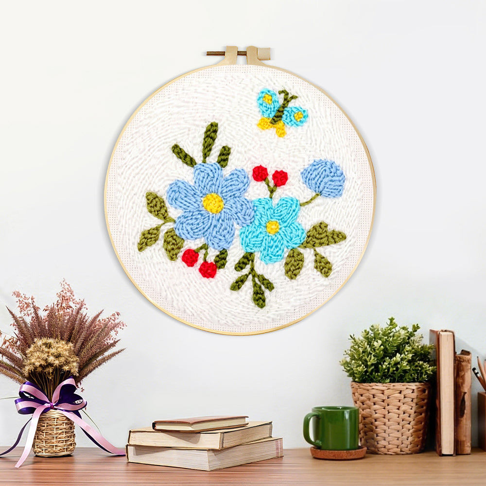 Finished blue flowers and little butterfly artwork displayed on a wall