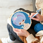 Creating handmade blue haired girl with bird punch needle artwork