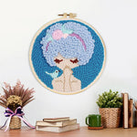 Finished blue haired girl with bird artwork displayed on a wall