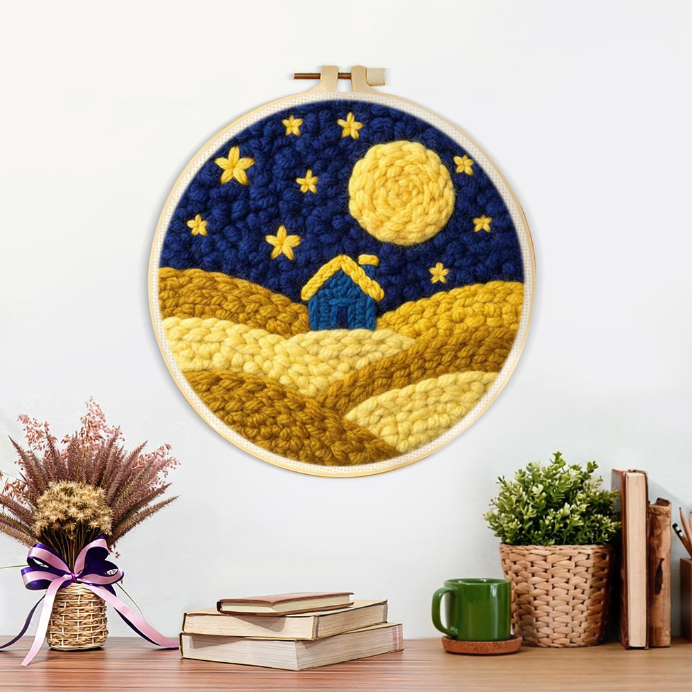 Finished blue house on yellow hills under the starry sky artwork displayed on a wall