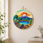 Blue lake, green trees and snow mountain needle felt wall art displayed in a bright home interior