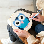 Creating handmade blue owl punch needle artwork
