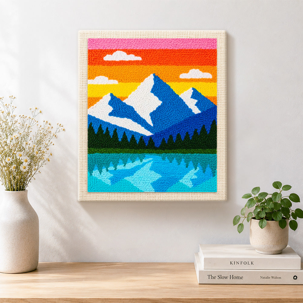 Finished blue peaks and lake reflection artwork displayed on a wall
