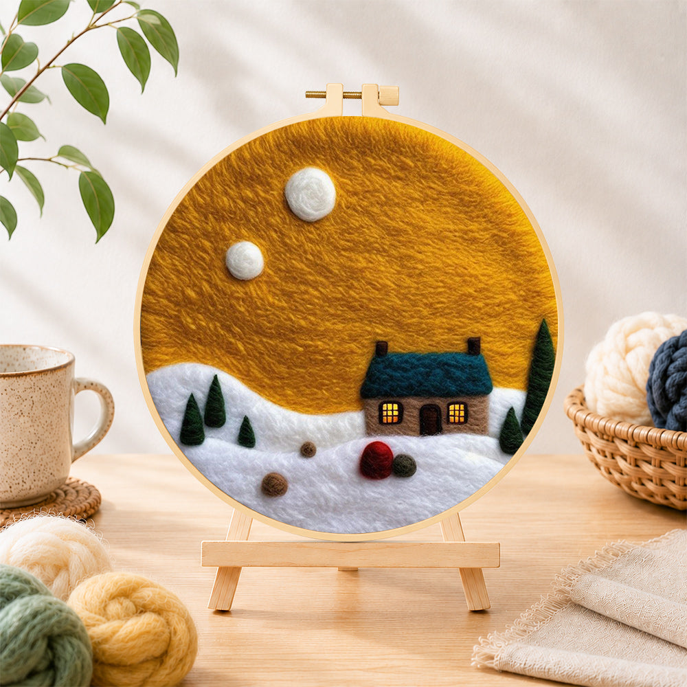 Finished blue-roof cottage under the yellow sky needle felting displayed on a wooden easel