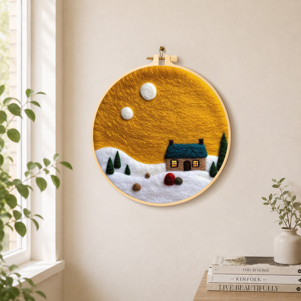 Blue-roof cottage under the yellow sky needle felt wall art displayed in a bright home interior