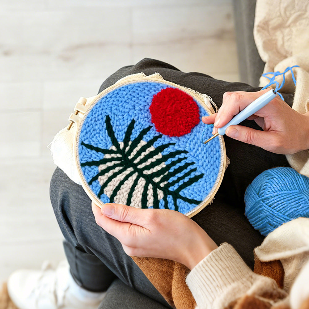 Creating handmade blue sky botanical with red sun punch needle artwork