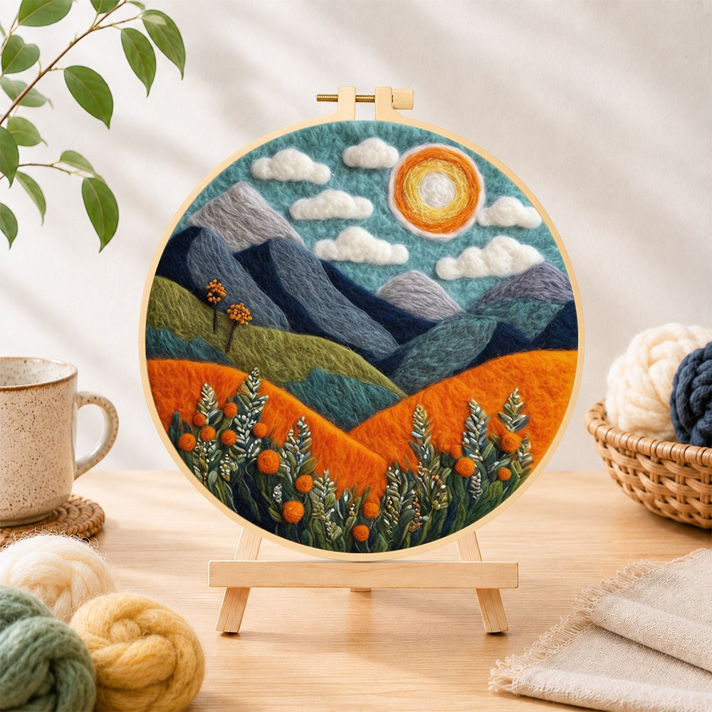 Finished blue terrain under the sun needle felting displayed on a wooden easel