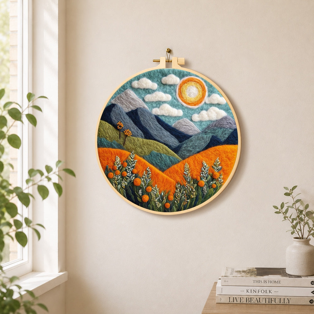 Blue terrain under the sun needle felt wall art displayed in a bright home interior