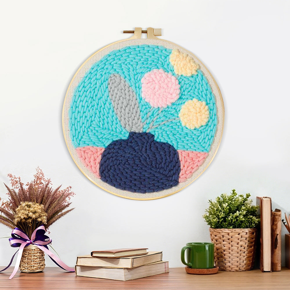 Finished blue vase with pastel flowers artwork displayed on a wall