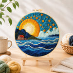 Finished blue waves under the golden sunset needle felting displayed on a wooden easel