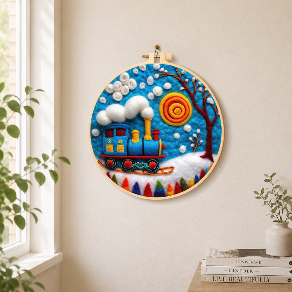 Blue winter train with swirling sun needle felt wall art displayed in a bright home interior