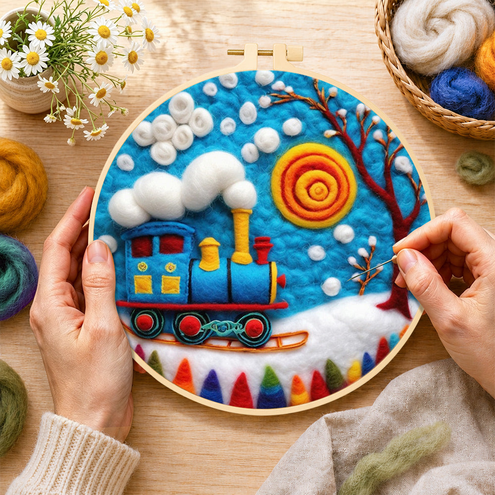 Creating the blue winter train with swirling sun wool painting by hand with a felting needle
