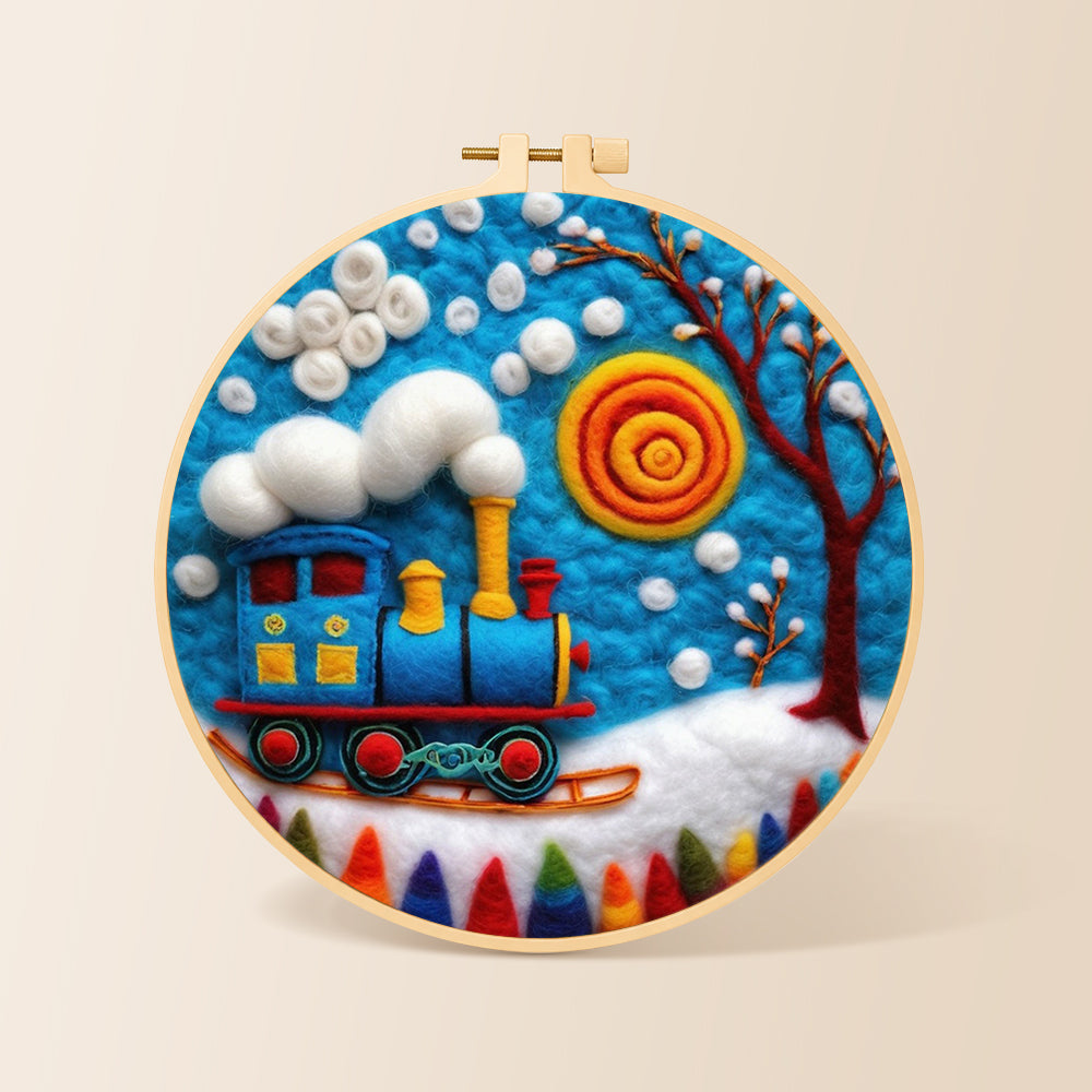 Blue winter train with swirling sun needle felting kit for beginners with a round wooden frame