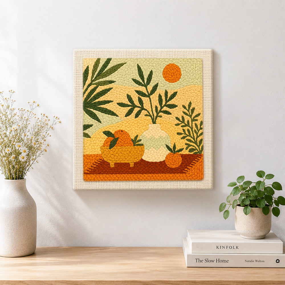 Finished boho leaves, oranges and sun artwork displayed on a wall