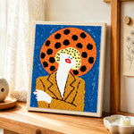 Bold pop art woman punch needle artwork displayed on a table