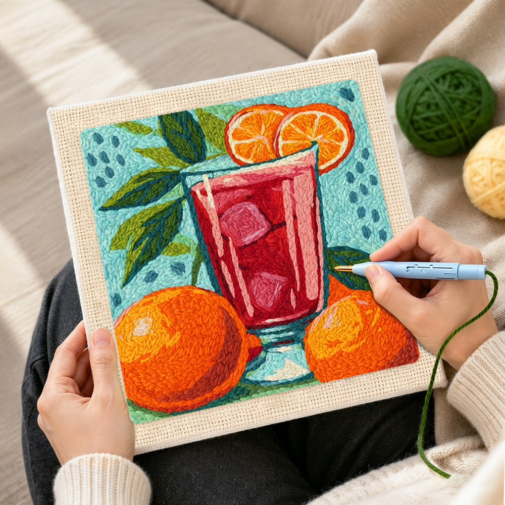 Creating handmade bold red drink with oranges punch needle artwork