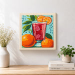Finished bold red drink with oranges artwork displayed on a wall