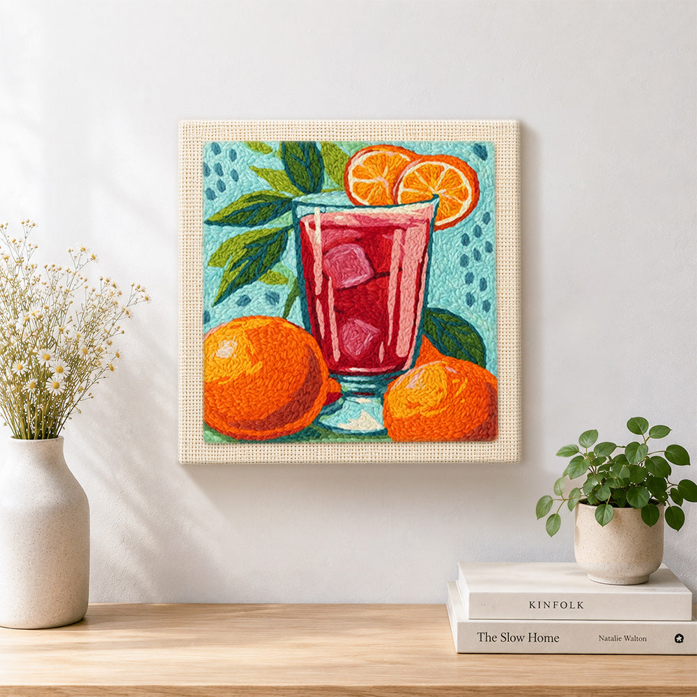 Finished bold red drink with oranges artwork displayed on a wall