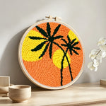 Bold sunset palm silhouette punch needle artwork displayed on a table