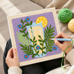 Creating handmade botanical yellow drink punch needle artwork
