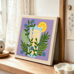 Botanical yellow drink punch needle artwork displayed on a table