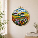 Bountiful wildflower field and summer cottage needle felt wall art displayed in a bright home interior